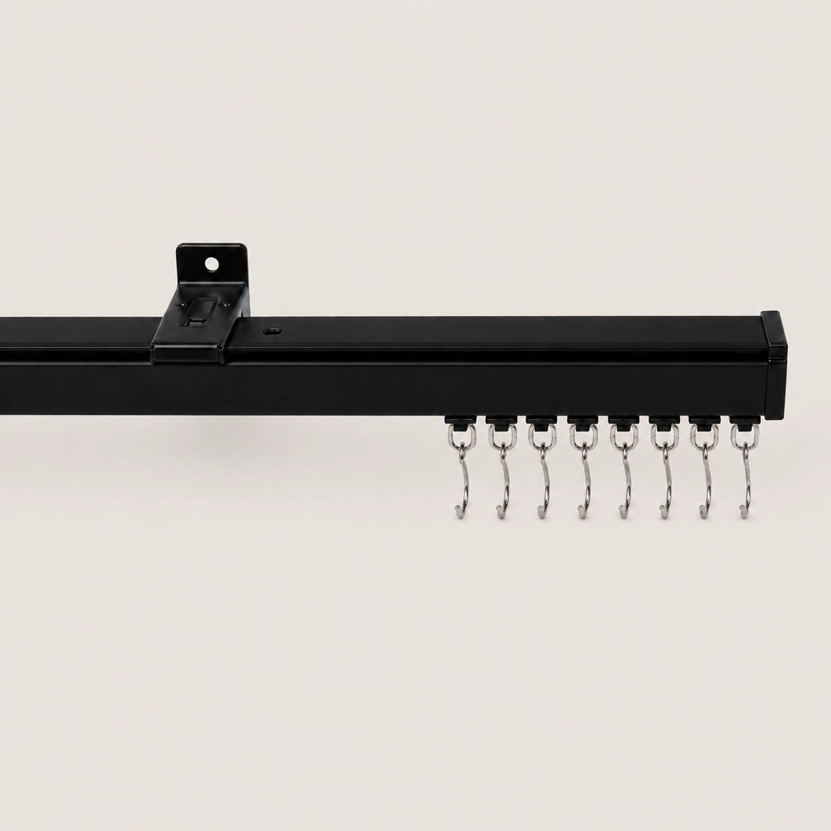 Black Mira ceiling track with white roller hooks and mounting bracket.