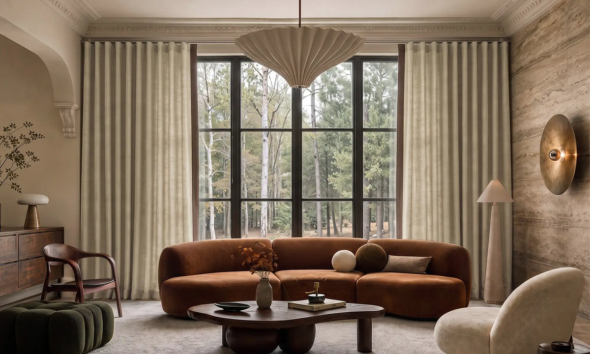 ripple fold curtains framing a bright window in a neutral interior, from an alternate angle.