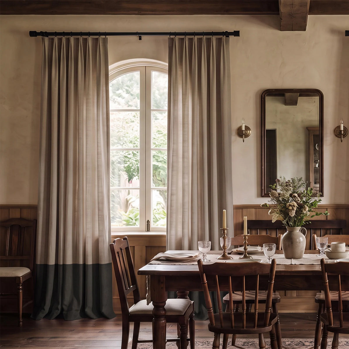 Two-tone tailored pleat curtains with a contrasting bottom border at a bright window.