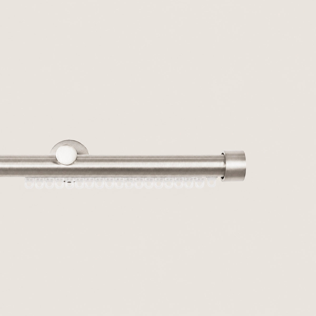 Brushed Silver Koda curtain rod with carrier track and compact end-cap finial.