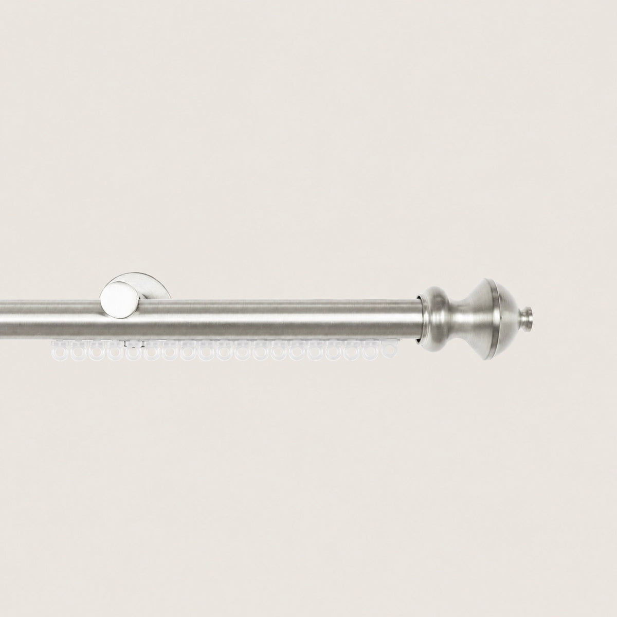 Brushed Silver Koda curtain rod with carrier track and tiered cylinder finial.