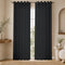 Charcoal gray aria fabric grommet curtains framing a bright window in a softly lit neutral room.