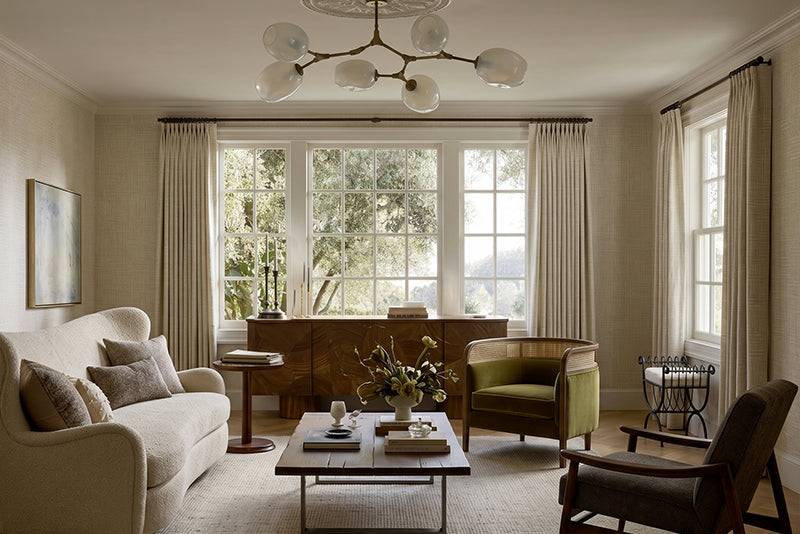 Bright neutral living room with coordinated Roman shades and curtains.