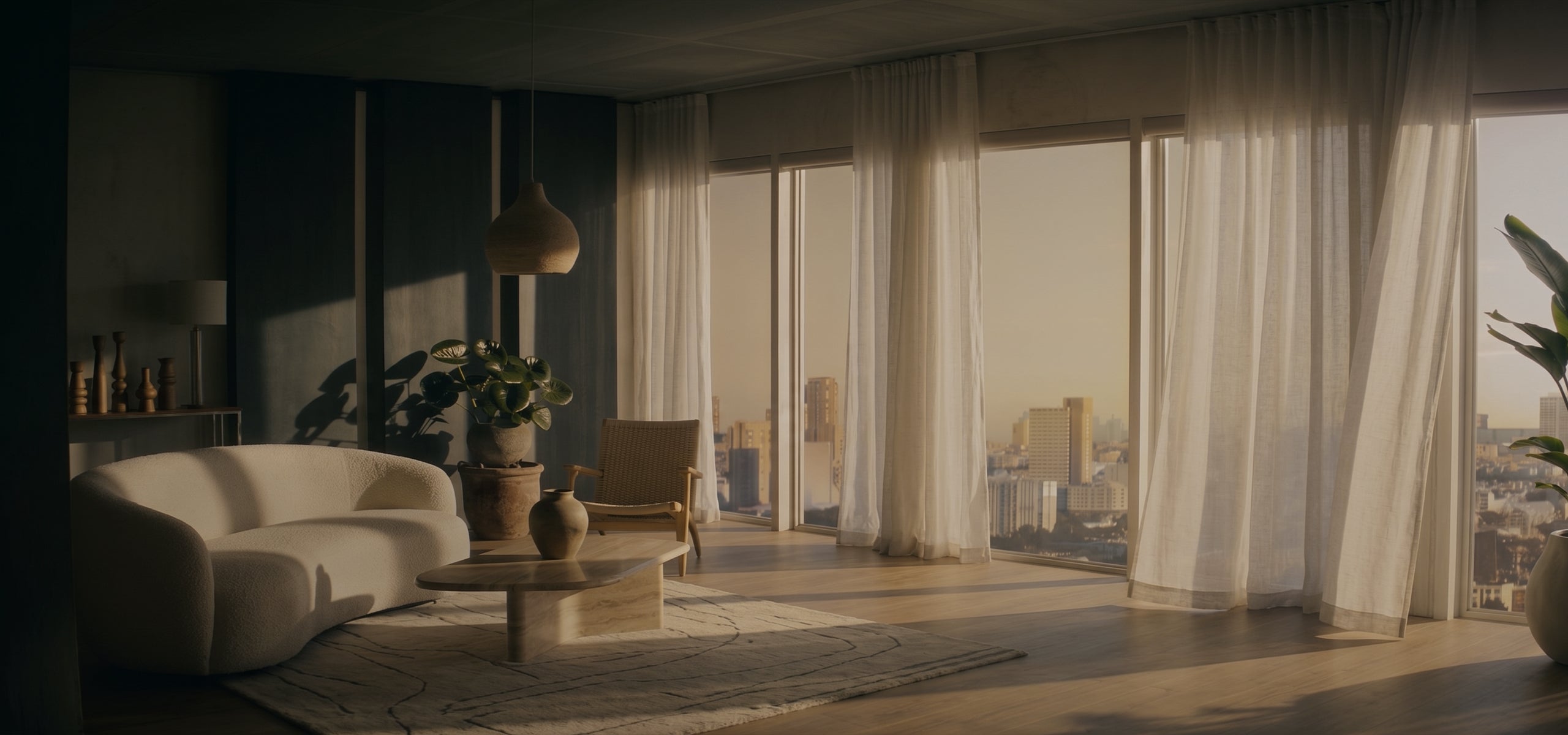 Wide neutral living room with layered curtains framing tall windows.
