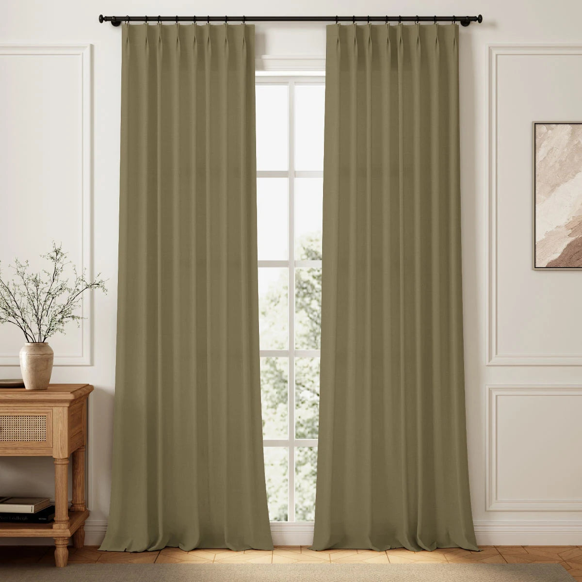 Khaki Aria pinch pleat curtains installed around a tall window in a neutral room.