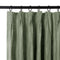 Kiwi linen curtains shown at the pleated header on a black rod.