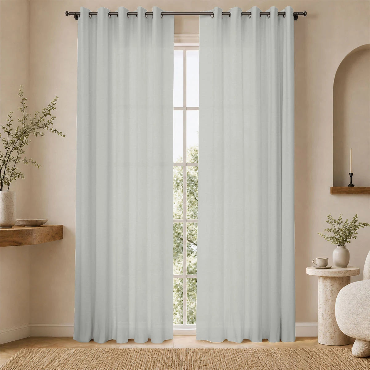 Natural aria fabric grommet curtains framing a bright window in a softly lit neutral room