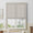 Zora Soft Flat Roman Shade in Toast – semi-raised linen-look roman blind installed on a large white-framed window in a bright, neutral-toned dining room with garden views