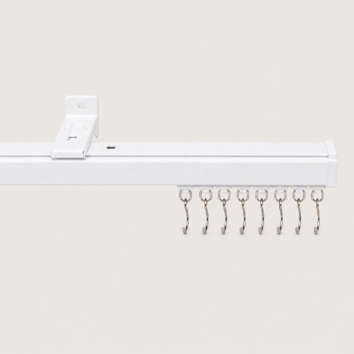White Mira ceiling track with matching roller hooks and mounting bracket.